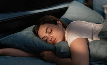 Woman sleeping peacefully in bed, promoting restful sleep and daily wellness